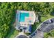 An aerial view of a pristine community pool with lounge chairs and shaded areas at 4211 Kingsfield Dr, Parrish, FL 34219