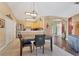 Dining area with tile floors, modern lighting, and open view to the kitchen and living area at 4211 Kingsfield Dr, Parrish, FL 34219