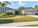 Charming single-story home featuring a well-manicured lawn, lush landscaping, and an attached two-car garage at 4211 Kingsfield Dr, Parrish, FL 34219