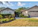 Charming single-story home with well-manicured lawn, mature landscaping, and attached two-car garage at 4211 Kingsfield Dr, Parrish, FL 34219