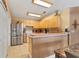 Bright kitchen featuring stainless steel refrigerator, tile flooring, and light wood cabinetry at 4211 Kingsfield Dr, Parrish, FL 34219