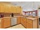 View of the kitchen with stainless steel appliances, wooden cabinetry, and double basin sink at 4211 Kingsfield Dr, Parrish, FL 34219
