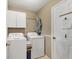 Bright laundry room featuring a washer, dryer, and convenient storage space at 4211 Kingsfield Dr, Parrish, FL 34219
