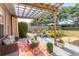 Relaxing patio with pergola, comfortable seating, and lush landscaping at 4211 Kingsfield Dr, Parrish, FL 34219