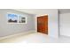 Bedroom with gray walls, terrazzo floor, and a closet with wood doors at 4229 Alna Way, Sarasota, FL 34232