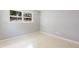 This bedroom has neutral paint, terrazzo floors, and natural light at 4229 Alna Way, Sarasota, FL 34232