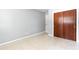 Bright bedroom with terrazzo flooring and large closet at 4229 Alna Way, Sarasota, FL 34232