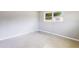 Sunlit bedroom with terrazzo flooring and A/C unit at 4229 Alna Way, Sarasota, FL 34232