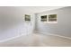 Bright bedroom with neutral walls, terrazzo floors, and a window air conditioning unit at 4229 Alna Way, Sarasota, FL 34232