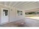Covered carport area with a door to the house and view of the street at 4229 Alna Way, Sarasota, FL 34232