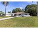 Quaint single-story home featuring a well-manicured lawn and covered carport at 4229 Alna Way, Sarasota, FL 34232