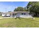 Cozy one-story home with carport, front lawn and mature trees in a suburban setting at 4229 Alna Way, Sarasota, FL 34232