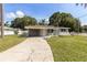 Quaint single-story home featuring a well-manicured lawn and covered carport at 4229 Alna Way, Sarasota, FL 34232
