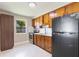 Cozy kitchen with wooden cabinets, stainless steel appliances, and a window view at 4229 Alna Way, Sarasota, FL 34232