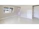 Bright living room featuring terrazzo floors, a window A/C unit, and natural light at 4229 Alna Way, Sarasota, FL 34232
