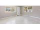 Bright living room featuring terrazzo floors, a window, and a white front door at 4229 Alna Way, Sarasota, FL 34232