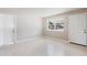 Neutral living room with terrazzo floors, a window, and multiple electrical outlets at 4229 Alna Way, Sarasota, FL 34232