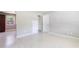 Bright living room with neutral walls and floors, featuring a window and multiple doorways at 4229 Alna Way, Sarasota, FL 34232