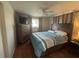This bedroom features hardwood floors, a large dresser, and a ceiling fan at 4411 Dolphin Ln, Palmetto, FL 34221