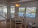 Bright dining area with view of the pool and canal at 4411 Dolphin Ln, Palmetto, FL 34221