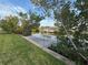 This dock on the water is surrounded by lush greenery and calm waters at 4411 Dolphin Ln, Palmetto, FL 34221