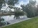 This wooden dock on the water offers a serene space to enjoy the natural surroundings at 4411 Dolphin Ln, Palmetto, FL 34221