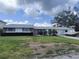 Charming single-story home with well-maintained lawn, beautiful landscaping, and a boat ready for the water at 4411 Dolphin Ln, Palmetto, FL 34221