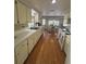 Well-lit kitchen featuring countertops, wood floors, and window to the back yard at 4411 Dolphin Ln, Palmetto, FL 34221