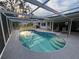 This in-ground pool has clear blue water, steps, and a screened enclosure at 4411 Dolphin Ln, Palmetto, FL 34221