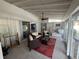 Bright sunroom with comfortable seating, a ceiling fan, and sliding glass doors at 4411 Dolphin Ln, Palmetto, FL 34221