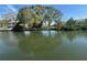 A serene water view featuring lush trees reflecting on the calm water at 4411 Dolphin Ln, Palmetto, FL 34221