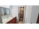 Well-lit bathroom with a wood vanity, marble countertop, a glass shower, and wood-look tile at 4415 45Th W Ave # 203, Bradenton, FL 34210