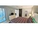 Bright bedroom with light walls, slider access to the lanai, and views into the ensuite bath at 4415 45Th W Ave # 203, Bradenton, FL 34210