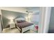Cozy bedroom featuring a white-painted wood bed frame, a ceiling fan, and soothing grey walls at 4415 45Th W Ave # 203, Bradenton, FL 34210