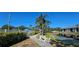 Scenic view of the community featuring a pond, walking path, and well-maintained landscaping at 4415 45Th W Ave # 203, Bradenton, FL 34210