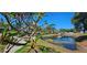 Picturesque waterway with blooming flowers and a view of the community's walking paths and buildings at 4415 45Th W Ave # 203, Bradenton, FL 34210