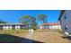 Exterior view of multi-Gathering residential buildings with mature trees, and well-manicured lawns at 4415 45Th W Ave # 203, Bradenton, FL 34210