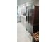A modern kitchen with stainless appliances, tile backsplash, and gray cabinets at 4415 45Th W Ave # 203, Bradenton, FL 34210
