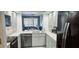 A modern kitchen with stainless appliances, tile backsplash, and views to the living area at 4415 45Th W Ave # 203, Bradenton, FL 34210