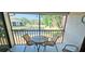 Screened lanai offering a scenic view of the lake and lush greenery, perfect for relaxation at 4415 45Th W Ave # 203, Bradenton, FL 34210