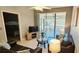 Comfortable living area showcasing modern furniture, a glass-topped table, and a doorway to a bedroom at 4415 45Th W Ave # 203, Bradenton, FL 34210