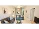 Comfortable living room with a leather sofa set, neutral walls, and bright lighting fixtures at 4415 45Th W Ave # 203, Bradenton, FL 34210