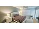 A neutral main bedroom with a queen bed, natural light and a ceiling fan at 4415 45Th W Ave # 203, Bradenton, FL 34210
