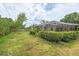 A spacious backyard with a screened enclosure and green grass, showcasing a private outdoor living space at 4415 Charing Cross Rd, Sarasota, FL 34241