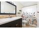 Bathroom with decorative shower curtain, floating shelves and decorative tile at 4415 Charing Cross Rd, Sarasota, FL 34241