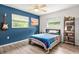 Bedroom features windows, a guitar, a bookshelf and a ceiling fan at 4415 Charing Cross Rd, Sarasota, FL 34241