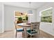 Bright dining area features a round table with stylish chairs and natural light at 4415 Charing Cross Rd, Sarasota, FL 34241