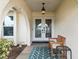 Cozy front porch features a bench, an accent rug, and double entry doors at 4415 Charing Cross Rd, Sarasota, FL 34241