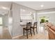 Open kitchen and dining area with granite countertops and modern white cabinets at 4415 Charing Cross Rd, Sarasota, FL 34241