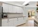 Bright kitchen featuring white cabinets, stainless steel appliances, and granite countertops at 4415 Charing Cross Rd, Sarasota, FL 34241